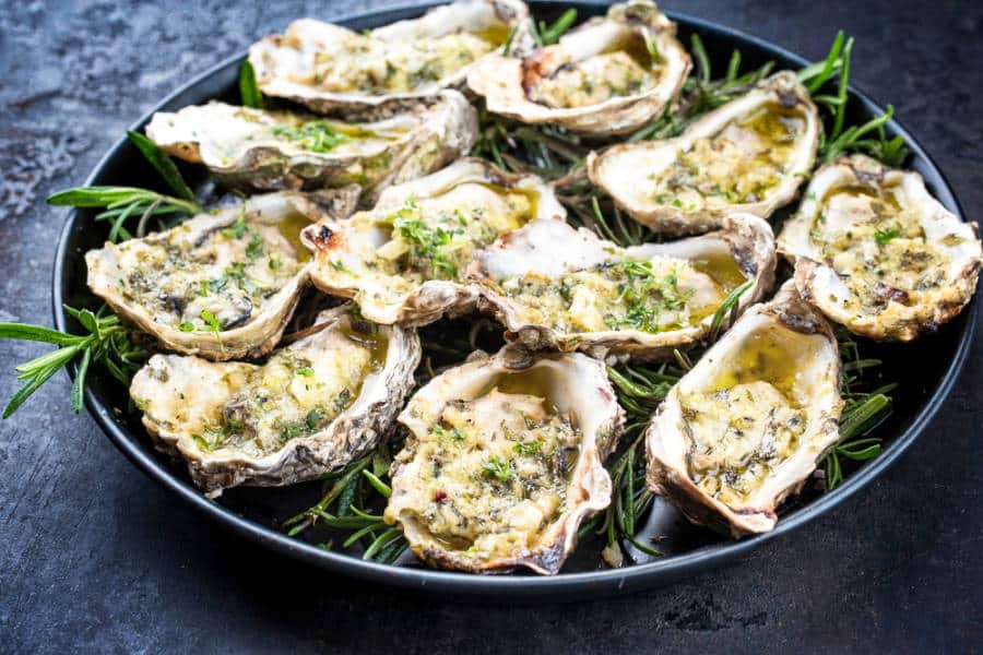 Closeup view of the baked oysters with butter and herbs
