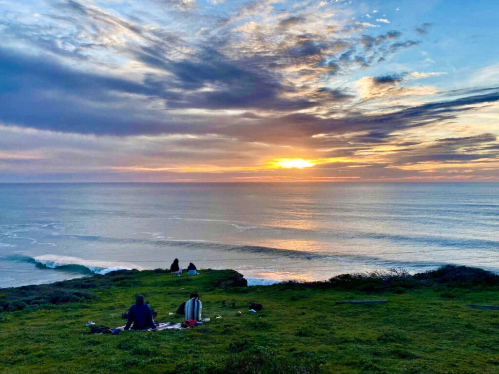 People enjoying the ocean sunset views in Pacifica