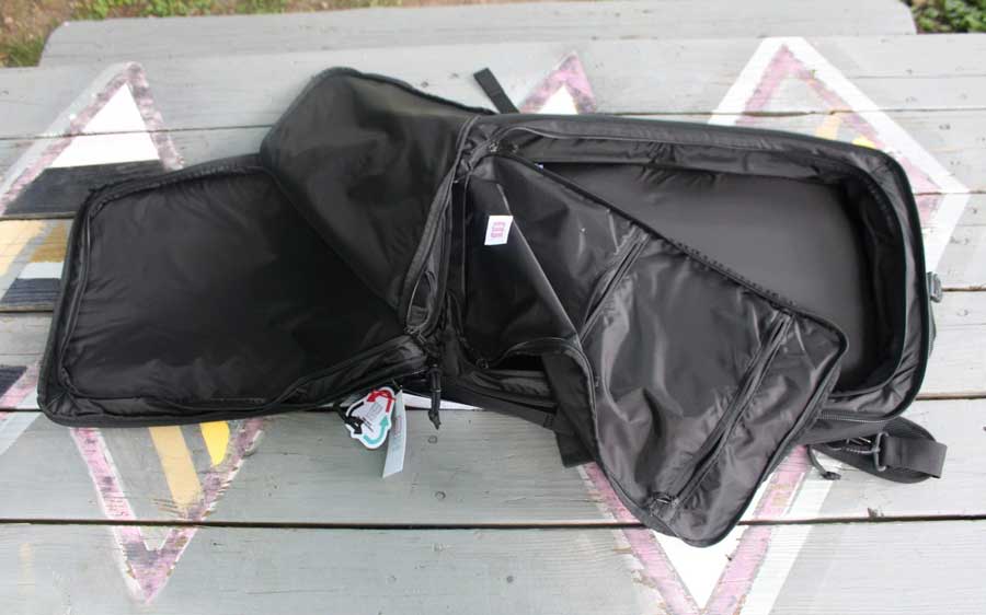 View of the built-in packing cubes on the interior of Topo Designs Global Travel Bag