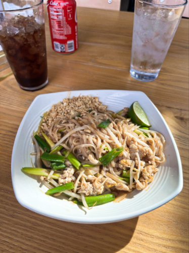 A plate of Pad Thai with soda on the side at Thai Esane