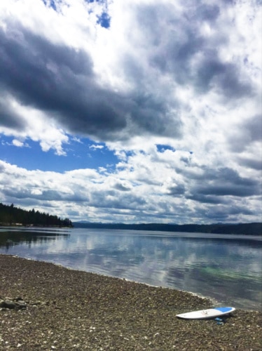 A paddleboard on the shoreline of Hood Canal on a cloudy day