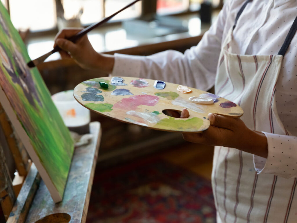 A person painting at Encinitas House of Art