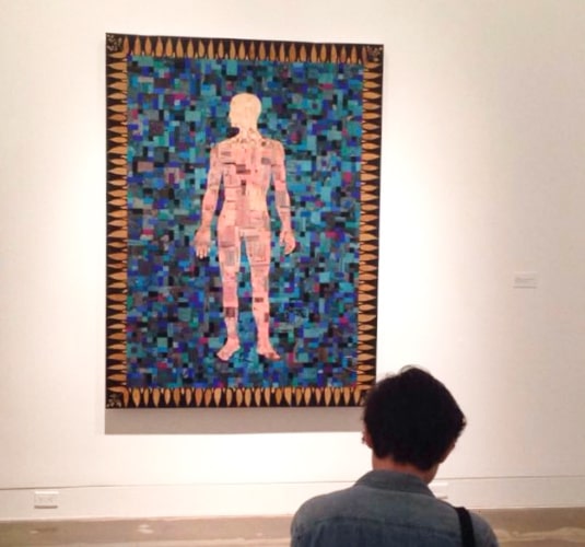 A man facing the artwork at Riverside Art Museum