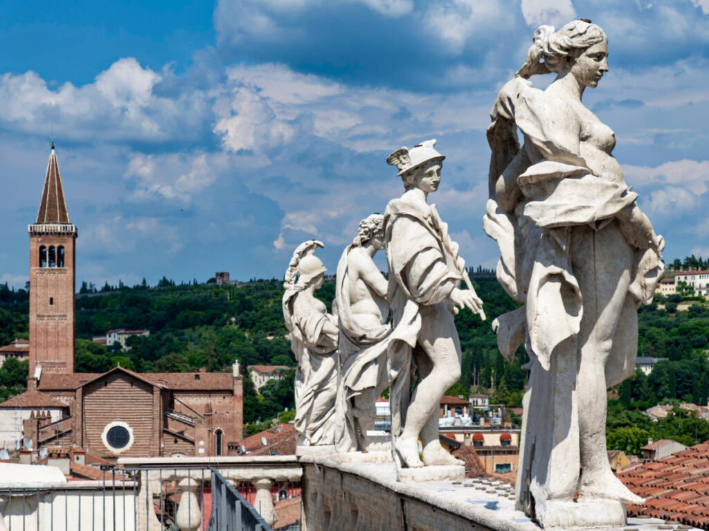 View of the lined statues on the top of Palazzo Maffei in Verona