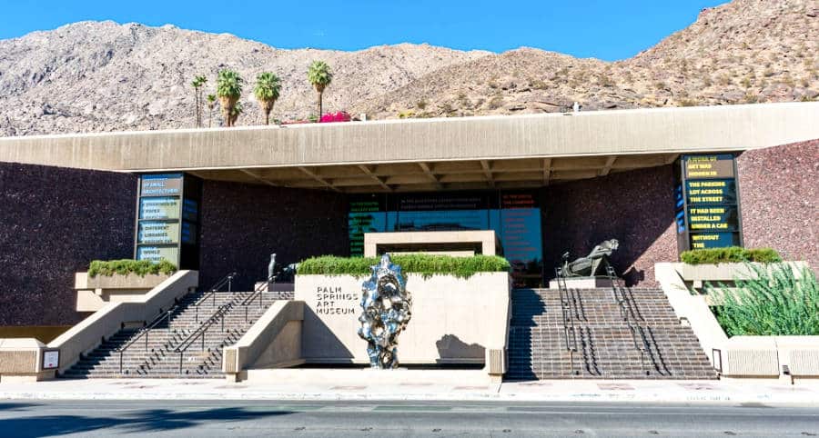 Façade and entrance view of Palm Springs Art Museum with a clear blue sky in California.
