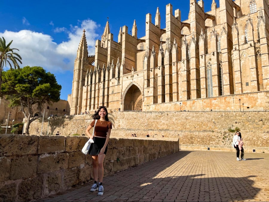 The author Lea Rose Allbaugh in front of the ancient Palma Cathedral