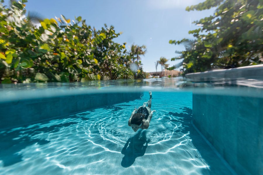 A woman having a swim on the pool in Palmaïa Hotel