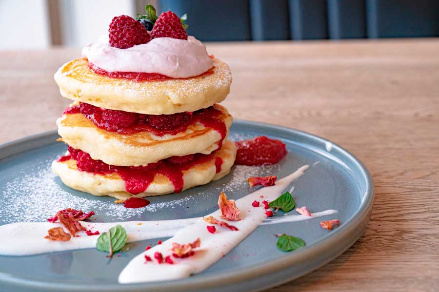 A plate of pancakes with strawberries on it