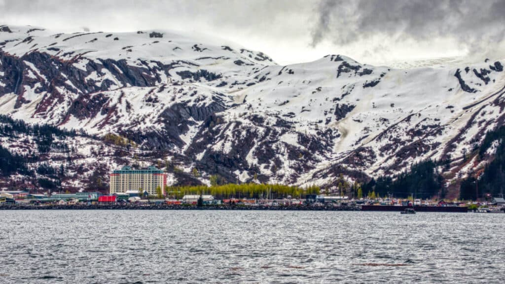 Panoramic view of the waterfront city of Whittier with the snowy mountain in the background