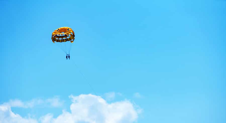 View of two people parasailing and the clear blue sky