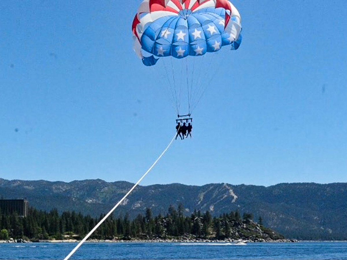 The author Laura McFarland and her friends, parasailing over the scenic views of Lake Tahoe