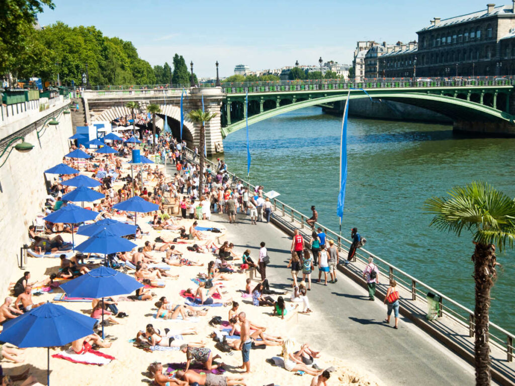View of the people chilling on the artificial sand near the Seine river