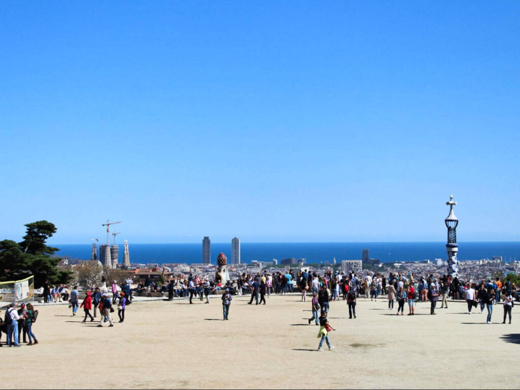 View of the crowd enjoying the sea views from Park Güell on a sunny day