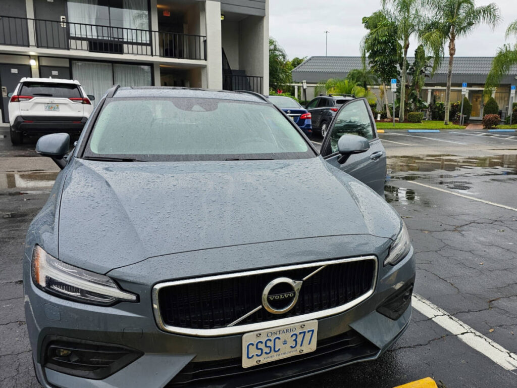 A modern car parked at the parking lot on a rainy day