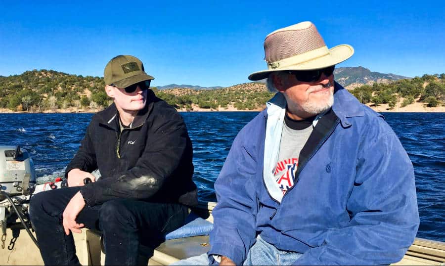 Two men on a boat looking for the best fishing spot in Parker Canyon Lake.