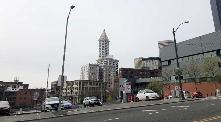 View of the Smith Tower near the parked cars on a parking lot