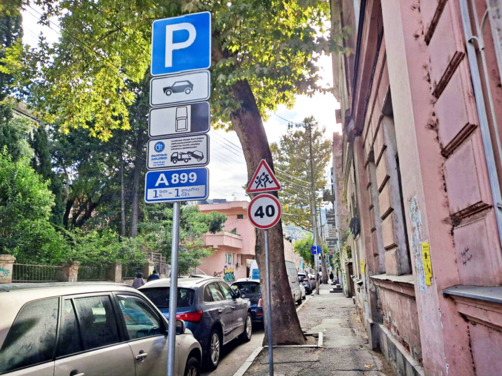 Parked cars near the parking signages in the street of Tbilisi