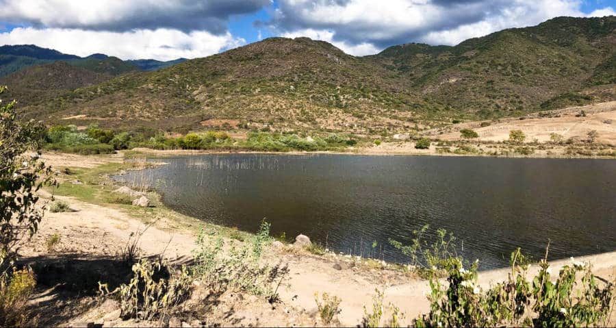 a bright and clear day at the lake surrounded by mountain ranges in Mexico