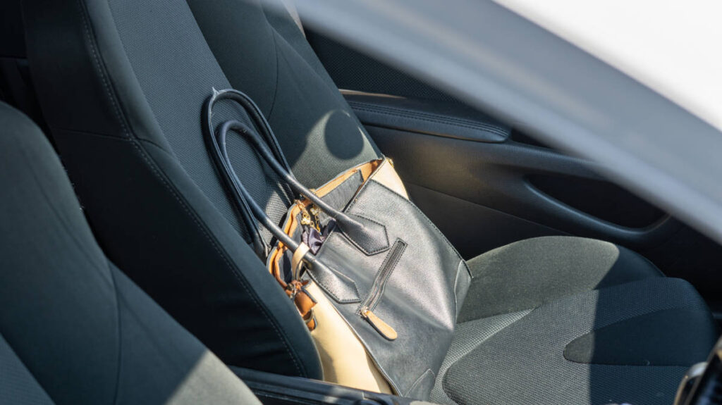 A bag on the passenger seat inside a car
