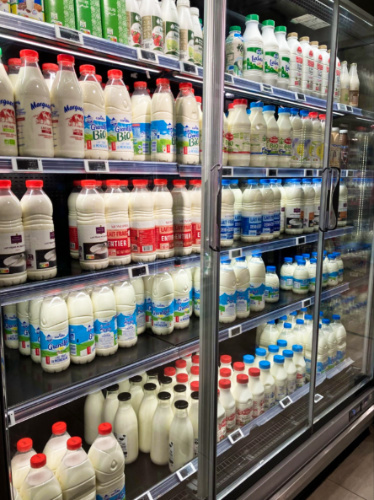A display shelf full of pasteurized milk