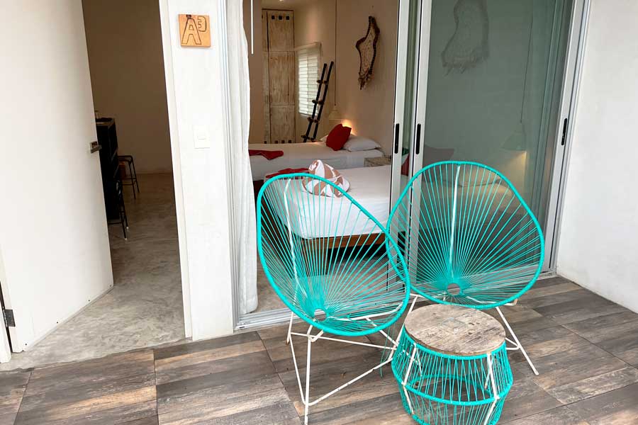 View of chairs and table outside the bedroom in Villas H20