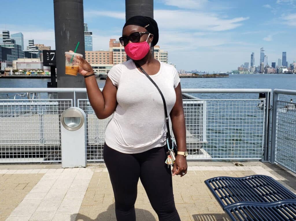 The author, Yvette Griffith posing for a photo while waiting for a ferry at Paulus Hook Ferry Terminal