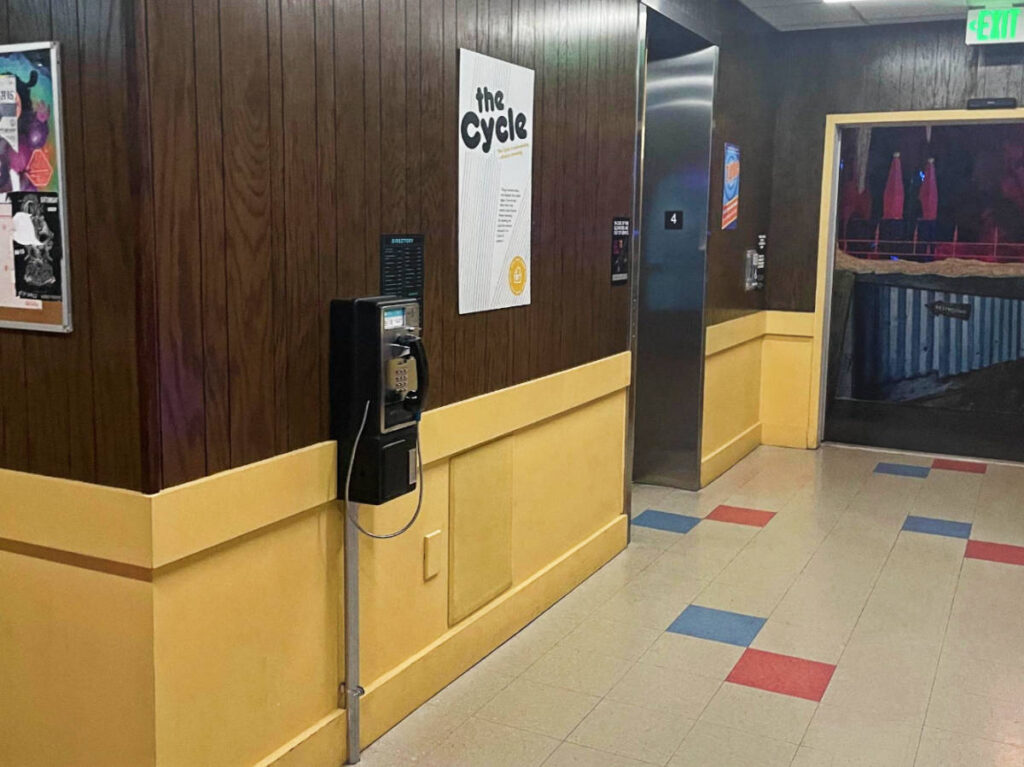 A payphone on a wall in Meow Wolf