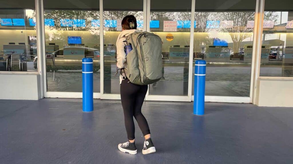 The author and her Peak Design Travel Backpack on her back ready to go
