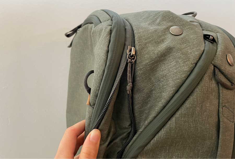 Close up view of the side zippers of Peak Design Travel Backpack