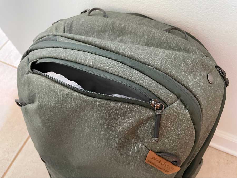 A small front pocket of the Peak Design Travel Backpack