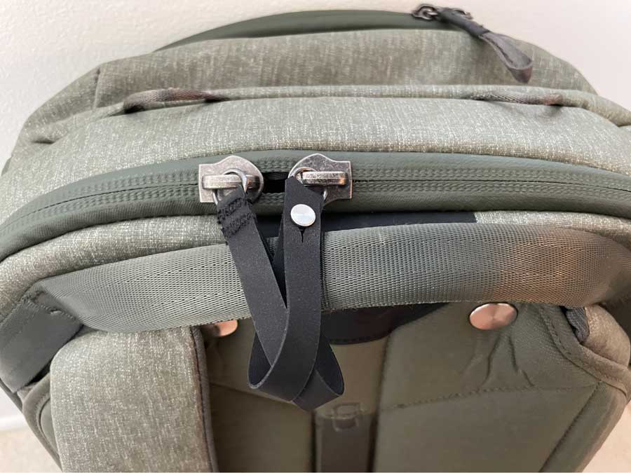Close up view of the zipper pulls of Peak Design Travel Backpack