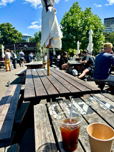 View of people enjoying their food at the picnic tables in Pear Tree Cafe