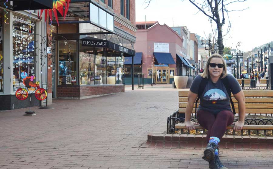 The author sitting on a bench in Pearl Street Mall