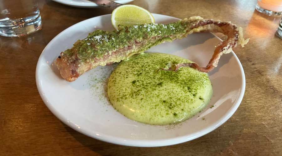 An octopus dish on a plate from Peninsula restaurant