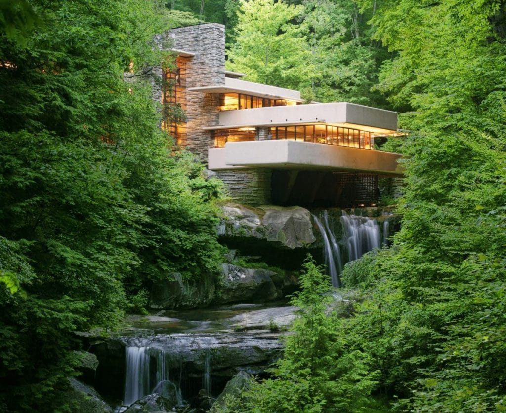 The waterfalls under the unique house in the middle of the woods