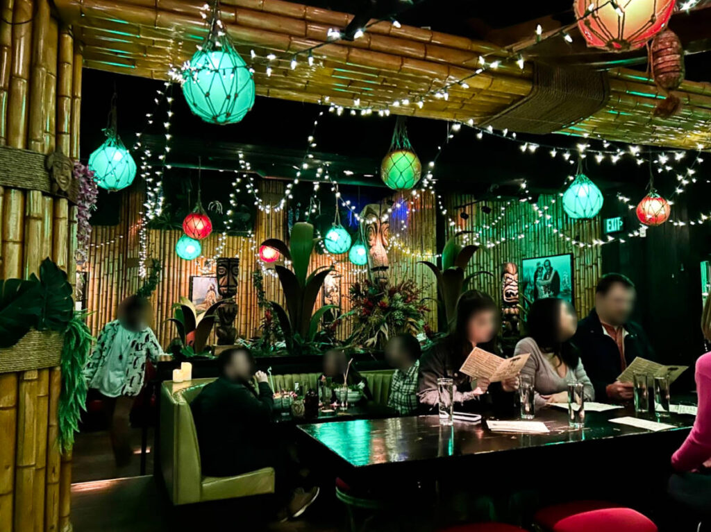 View of the people chilling inside the cozy interior of Adrift Tiki Bar