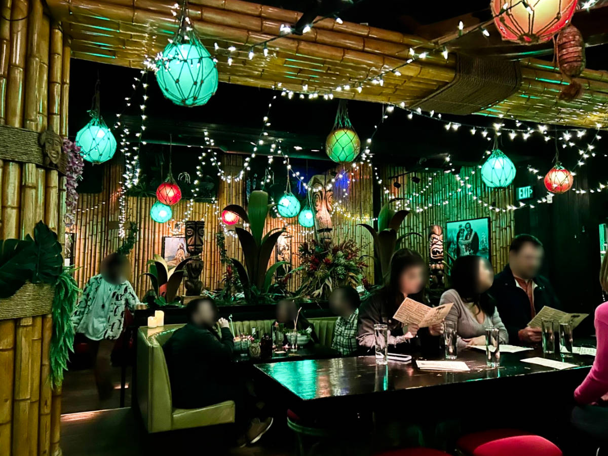 View of the people chilling inside the cozy interior of Adrift Tiki Bar