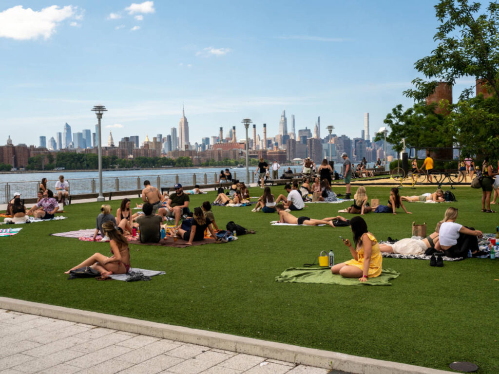People chilling at the Domino Park with skyline views