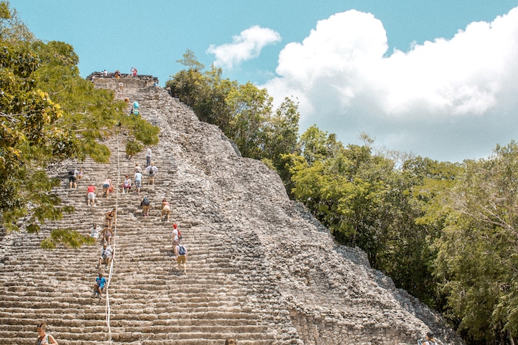 People climbing the ruins at Coba