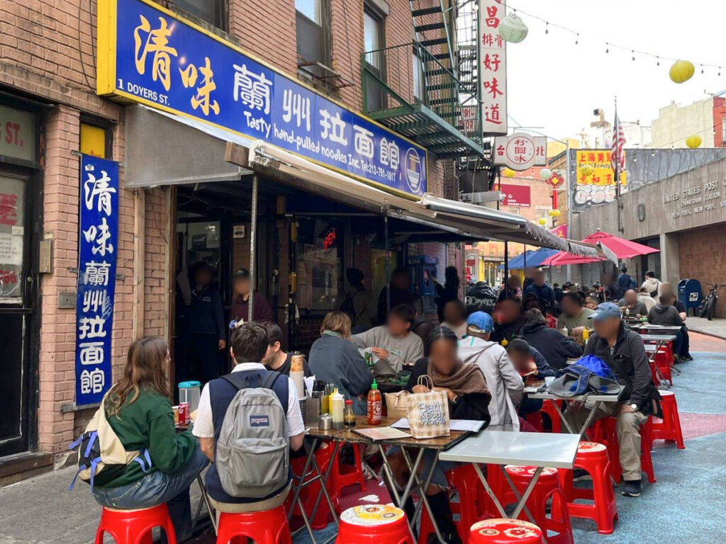 People dining outside a Chinese restaurant