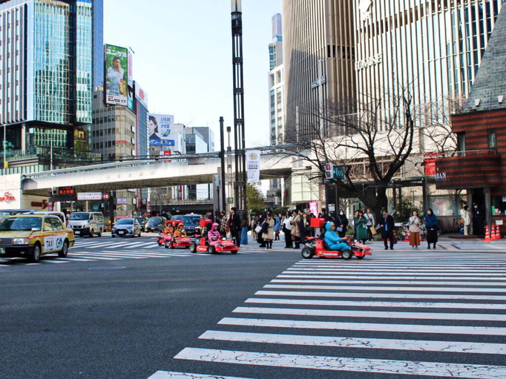 View of the people ridding a go-kart in the streets of Tokyo