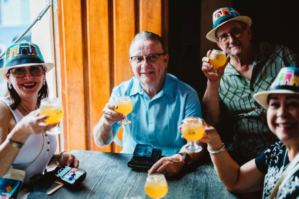 Group of people holding their glasses of drink up