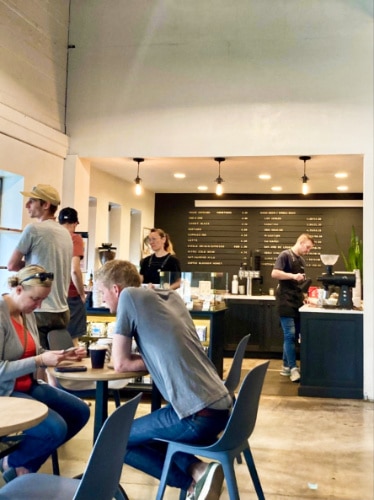 View of the people inside the Sweet Bloom Coffee Roasters in Lakewood