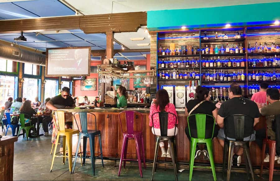 People dining and chilling at the bar counter of The Rum House