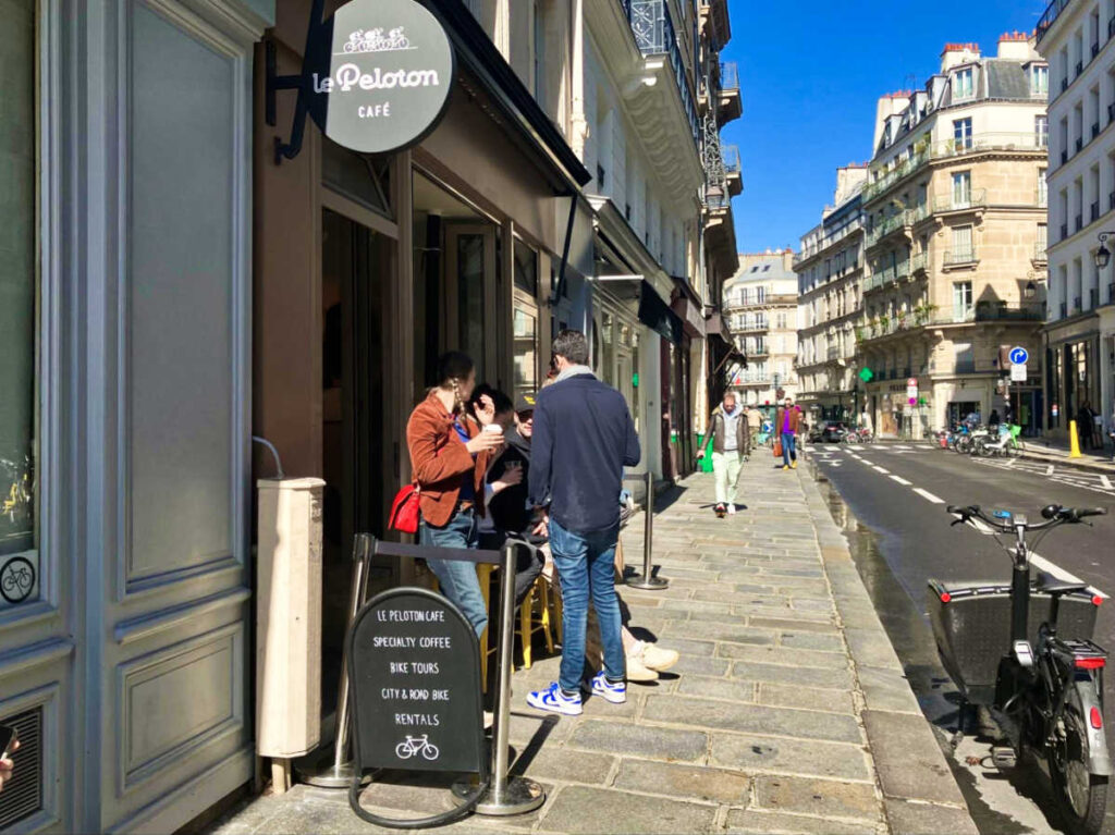 The people waiting outside the Le Peloton Café