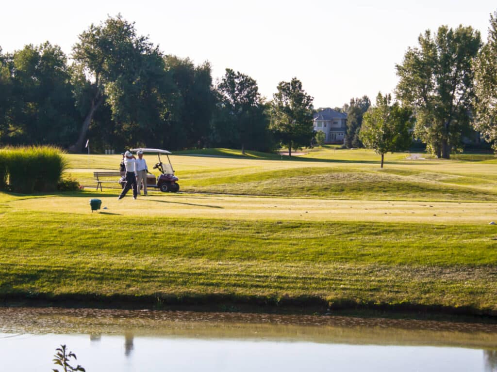 View of the people playing golf near the lake