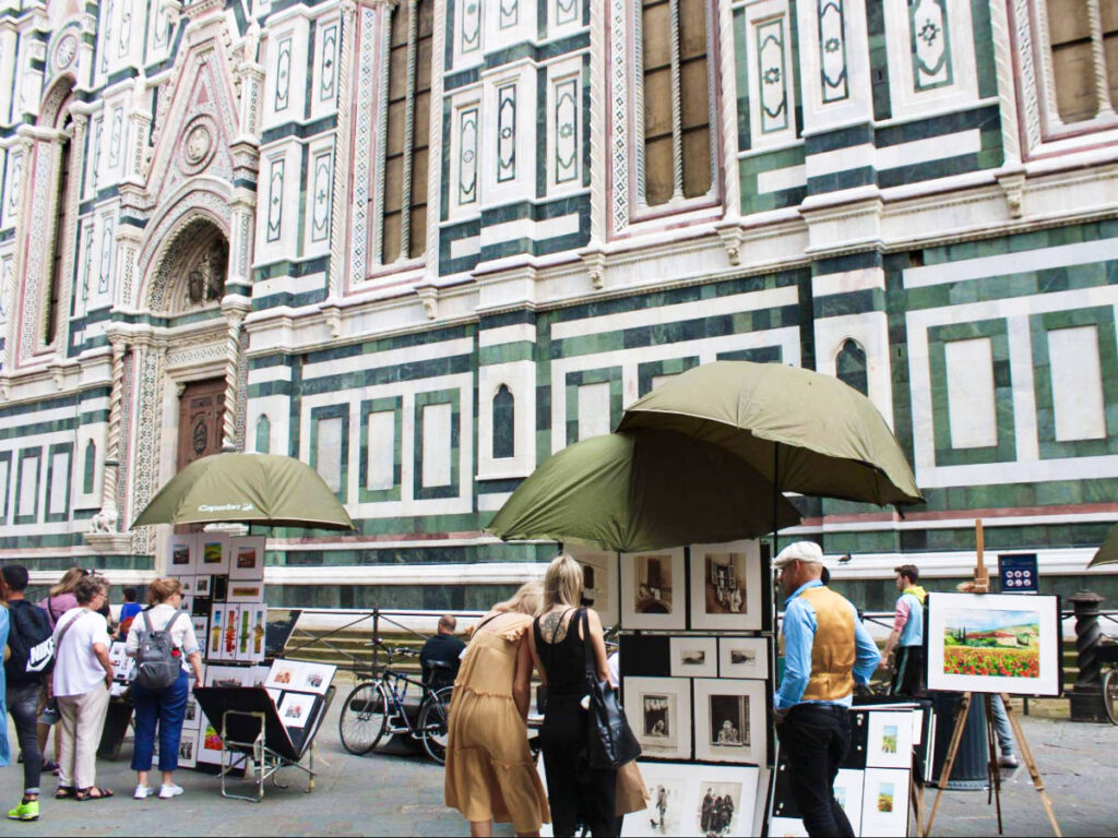 View of the people shopping art paintings in the street of Florence