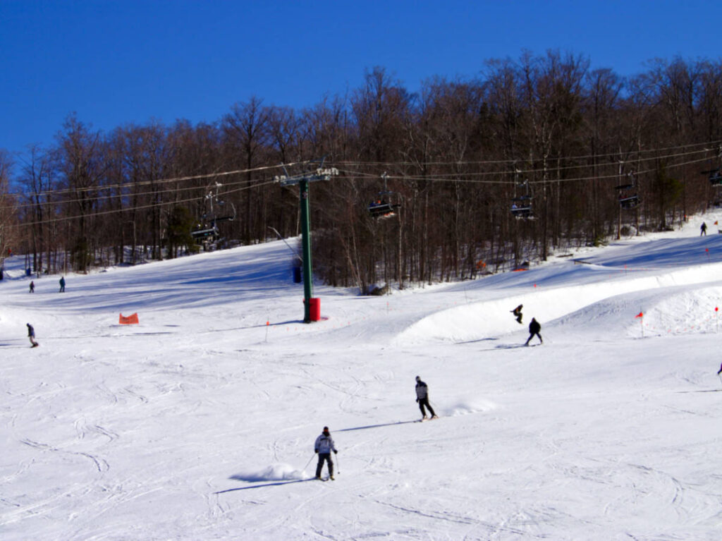 People skiing down on the trails at the mountain