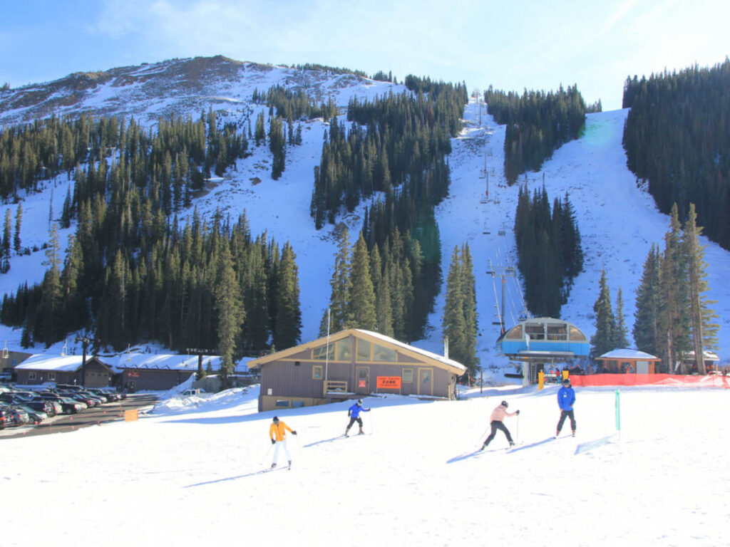 View of the people skiing with majestic mountain views at Loveland Ski Area
