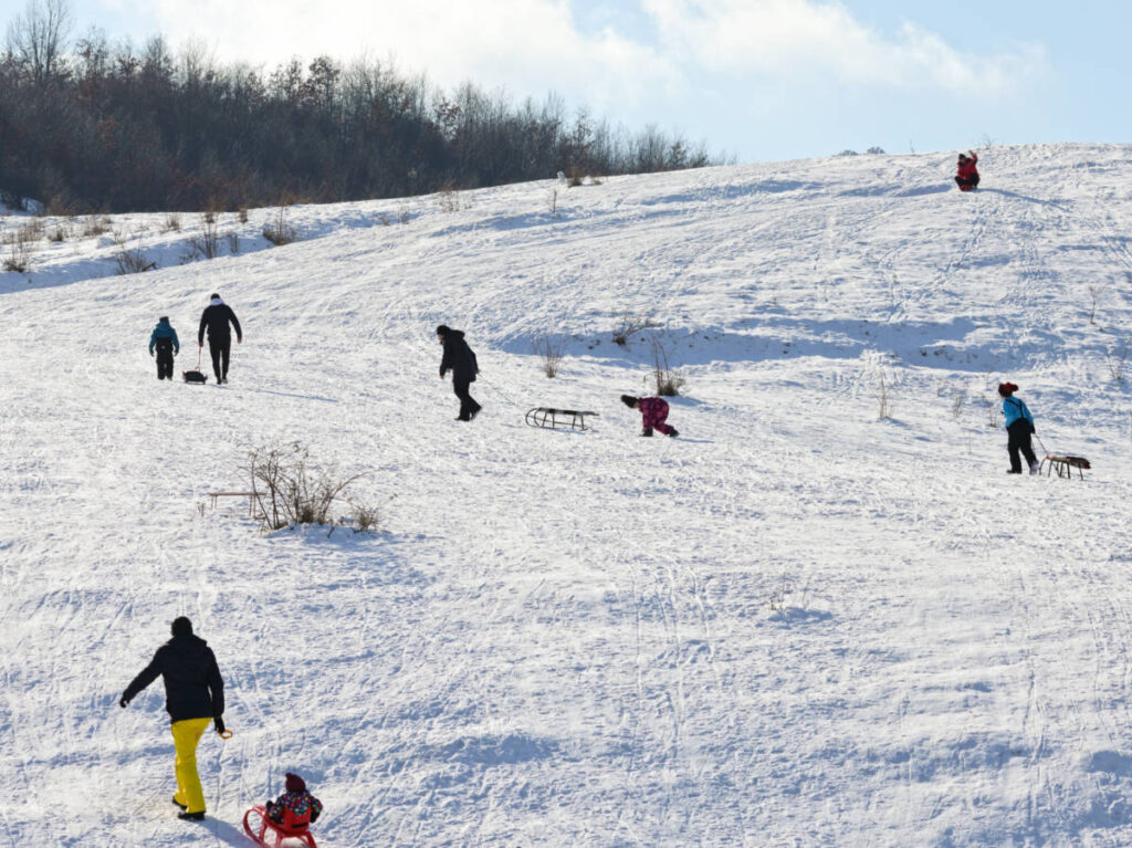 View of the people skiing and snowboarding on the hills